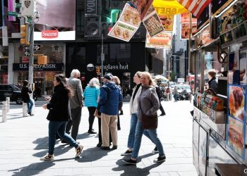 NEW YORK, NEW YORK - APRIL 27: People walk through Times Square on April 27, 2022 in New York City. Unlike other parts of Manhattan, Times Square is quickly returning to its pre-pandemic population with Broadway shows and area hotels at near full capacity on many nights. While office workers in Manhattan have yet to return in large numbers, Times Square is seeing a boom in tourists visiting the historic entertainment core of Manhattan. Dr. Anthony Fauci announced today the America is officially out of the pandemic stage of the Covid-19. (Photo by Spencer Platt/Getty Images)