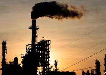 The sun sets behind smoke rising from the LyondellBasell-Houston Refining plant in Houston, Texas, on April 20, 2020. - US oil prices crashed to unprecedented lows on April 20 as futures in New York ended in negative territory for the first time amid a devastating supply glut that has forced traders to pay others to take the crude off their hands. (Photo by Mark Felix / AFP) (Photo by MARK FELIX/AFP /AFP via Getty Images)