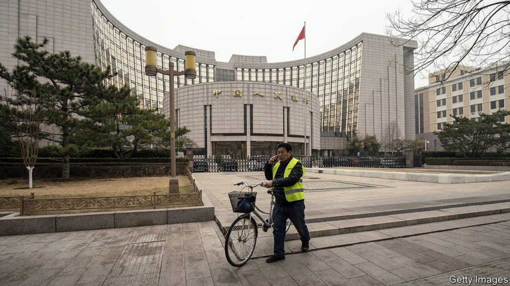 A person pushes a bike past the People's Bank of China (PBOC) building in Beijing, China, on Thursday, March 4, 2021. The low cost of borrowing in Chinas money markets suggests the central bank again has room to tighten policy by withdrawing liquidity from the financial system -- like it did in January. Photographer: Qilai Shen/Bloomberg via Getty Images
