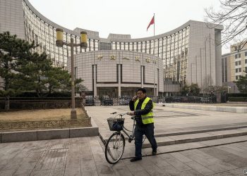 A person pushes a bike past the People's Bank of China (PBOC) building in Beijing, China, on Thursday, March 4, 2021. The low cost of borrowing in Chinas money markets suggests the central bank again has room to tighten policy by withdrawing liquidity from the financial system -- like it did in January. Photographer: Qilai Shen/Bloomberg via Getty Images