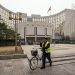 A person pushes a bike past the People's Bank of China (PBOC) building in Beijing, China, on Thursday, March 4, 2021. The low cost of borrowing in Chinas money markets suggests the central bank again has room to tighten policy by withdrawing liquidity from the financial system -- like it did in January. Photographer: Qilai Shen/Bloomberg via Getty Images