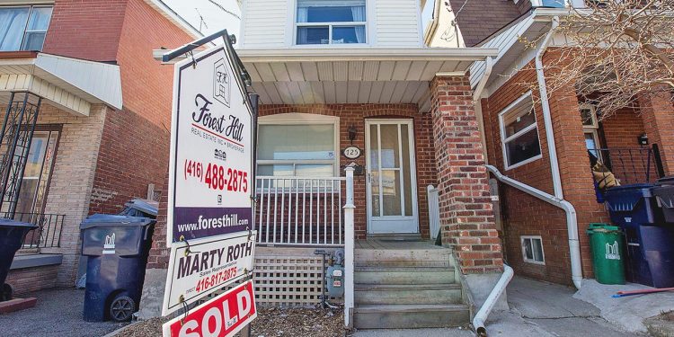 TORONTO, ON - MAY 6: The average sale price of a detached house in the City of Toronto is expected to hit $1 million in April for the first time. Active listings were down 8.4 per cent, a persistent problem which has been driving significant price growth. This home at near Ossington Avenue with a unique coach house in the back, sold for $1 million in April 2014. (Carlos Osorio/Toronto Star via Getty Images)