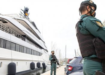 Civil Guards stand by the yacht called Tango in Palma de Mallorca, Spain, Monday April 4, 2022. U.S. federal agents and Spain's Civil Guard are searching the yacht owned by a Russian oligarch. The yacht is among the assets linked to Viktor Vekselberg, a billionaire and close ally with Russia's President Vladimir Putin, who heads the Moscow-based Renova Group, a conglomerate encompassing metals, mining, tech and other assets, according to U.S. Treasury Department documents. All of Vekselberg's assets in the U.S. are frozen and U.S. companies are forbidden from doing business with him and his entities. (AP Photo/Francisco Ubilla)