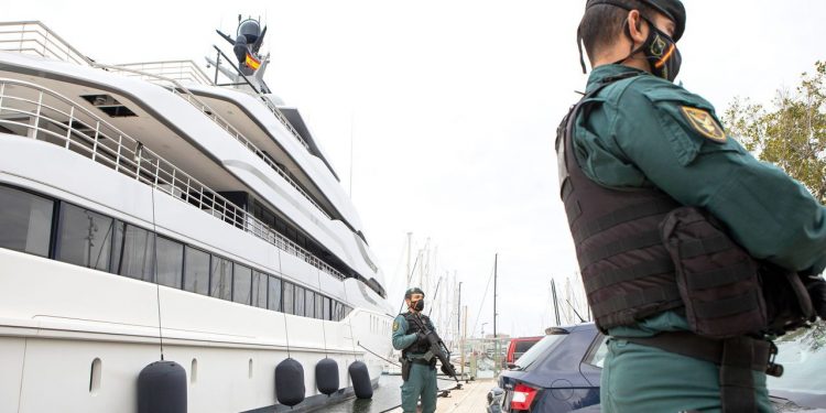 Civil Guards stand by the yacht called Tango in Palma de Mallorca, Spain, Monday April 4, 2022. U.S. federal agents and Spain's Civil Guard are searching the yacht owned by a Russian oligarch. The yacht is among the assets linked to Viktor Vekselberg, a billionaire and close ally with Russia's President Vladimir Putin, who heads the Moscow-based Renova Group, a conglomerate encompassing metals, mining, tech and other assets, according to U.S. Treasury Department documents. All of Vekselberg's assets in the U.S. are frozen and U.S. companies are forbidden from doing business with him and his entities. (AP Photo/Francisco Ubilla)